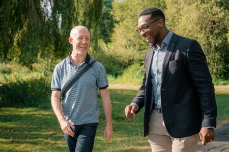 John and a participant talking while walking outdoors
